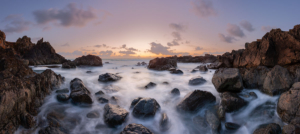 Tide rising around rocks at dusk near Pleinmont, Guernsey.